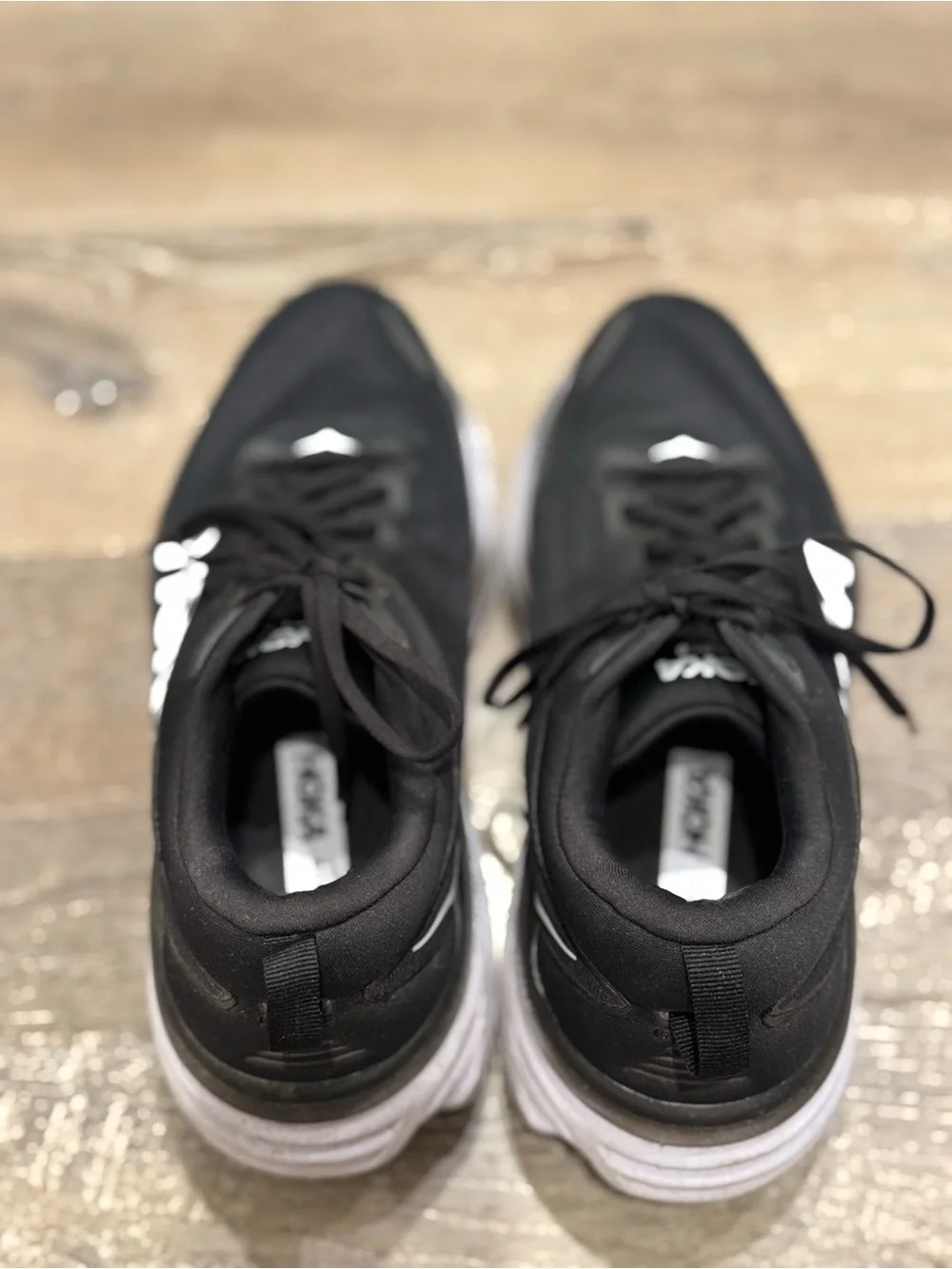 Hoka One One Bondi 8 running shoes feature a black upper and a white midsole